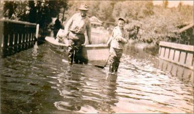 Dick Knarr and his son, Richard, pull a boat over the Beaver Creek Bridge during the flood of 1948. THS Photo.