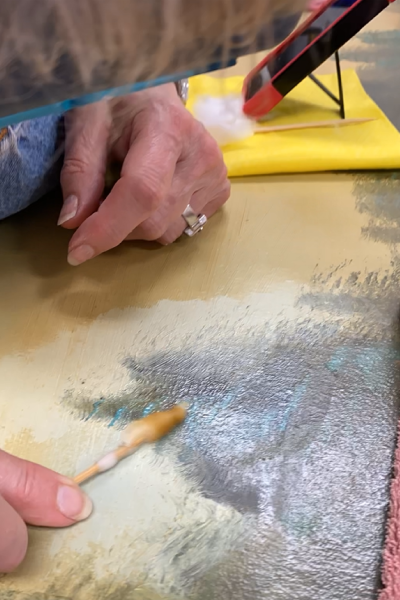 Art restorer Susan Scott-LaRue works on Troutdale's historic Multnomah Falls painting