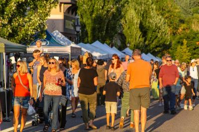 People stroll along the street in downtown Troutdale during First Friday