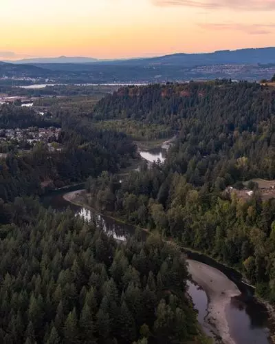 Aerial view of the Sandy River and surrounding forested area at sunset