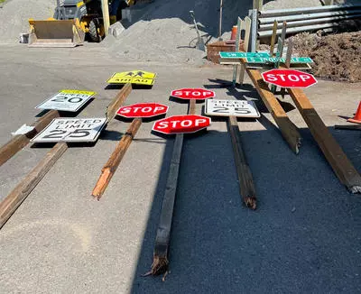 Broken street signs lying on the ground