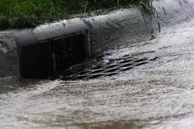 Water running down a street storm drain