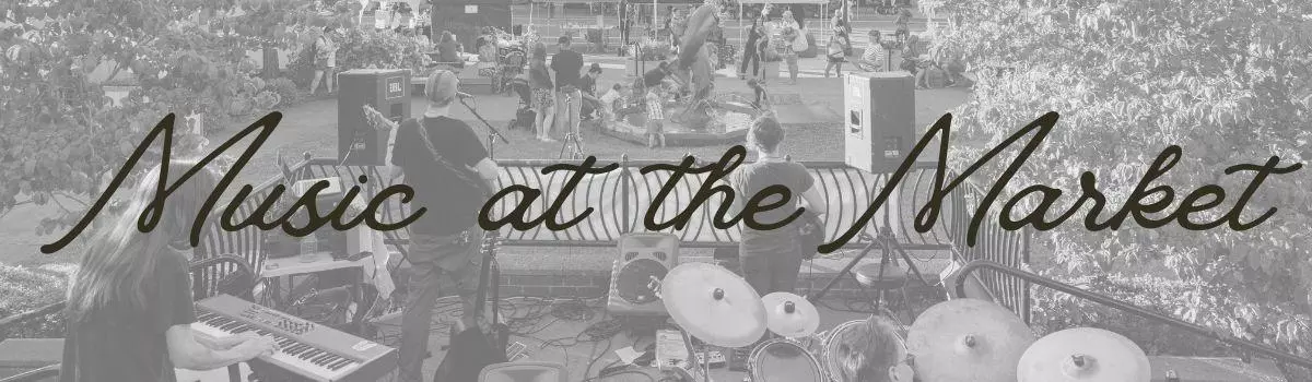 Black and white image of view from behind a band playing at Mayors Square