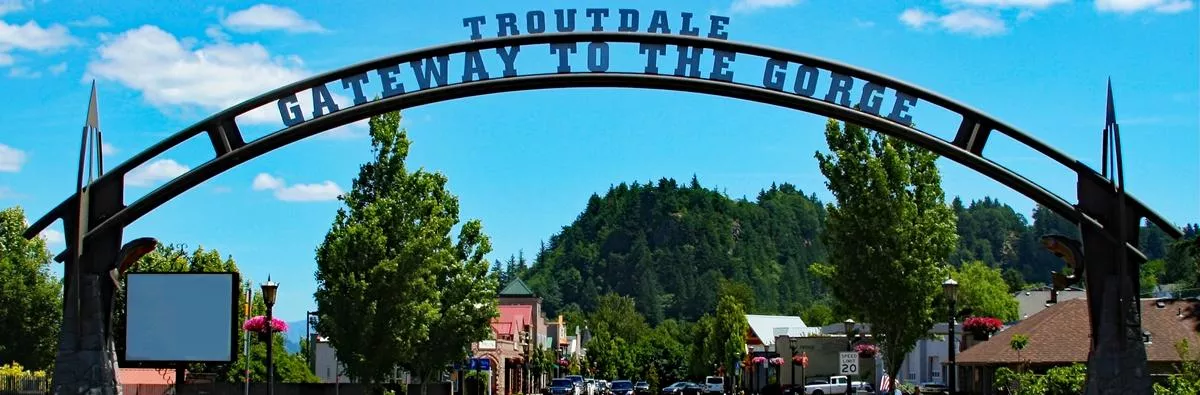 Troutdale's Centennial Arch under a bright blue sky on a summer day