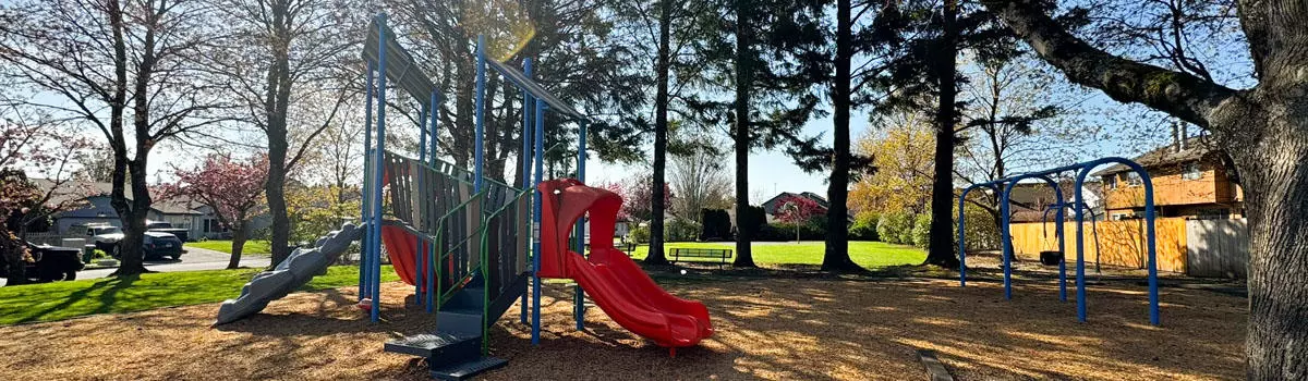 CP Park in Troutdale featuring playground equipment, swing set, and a basketball hoop in the background