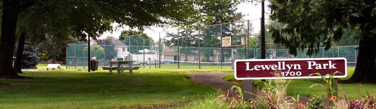 Lewellyn Park in Troutdale with tennis courts, a picnic table, walking paths and a grassy are