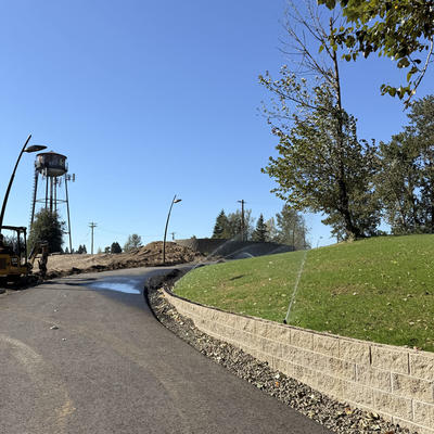 Trail with view of old water tower in Sharon Nesbit Heritage Park