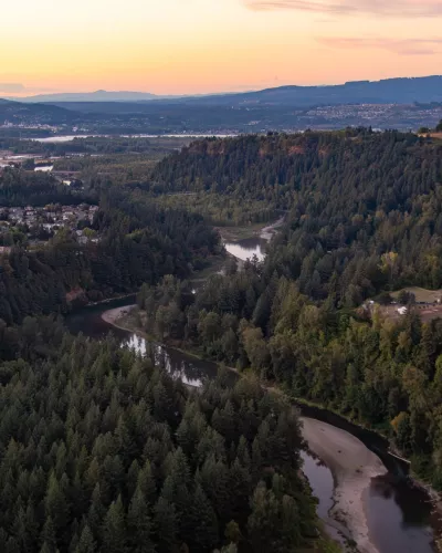 Aerial view of the Sandy River and surrounding forested area at sunset