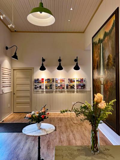 Interior view of the Gateway to the Gorge Visitor Center with the Multnomah Falls painting and travel brochures under lights
