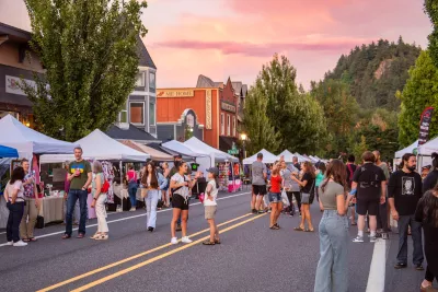 People stroll along the street in downtown Troutdale during First Friday