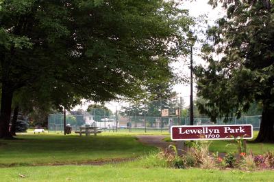 Sign at Lewellyn Park under a canopy of trees
