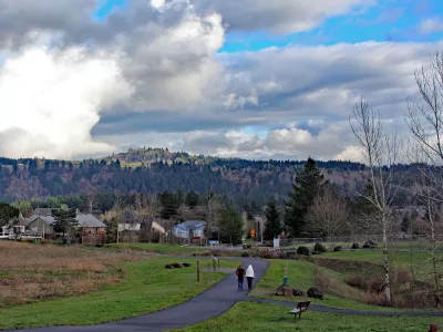 People walking on a paved path through Sunrise Park