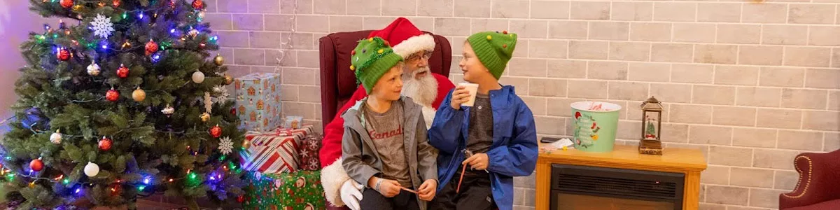 Kids sit on Santa's lap at Troutdale Windy Wonderland