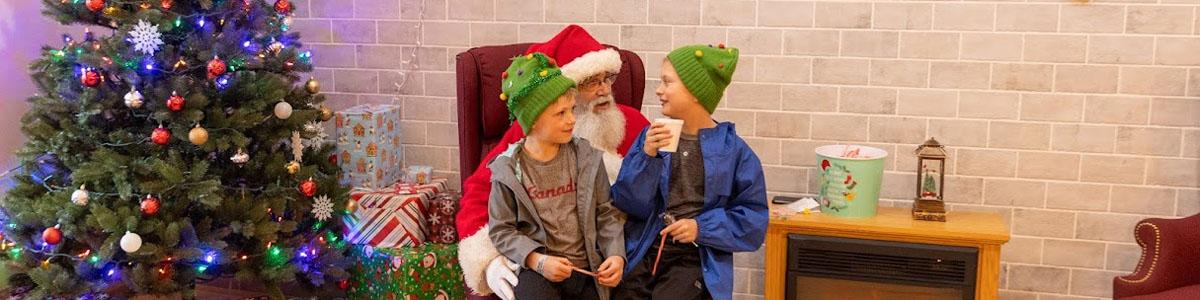 Kids sit on Santa's lap at Troutdale Windy Wonderland
