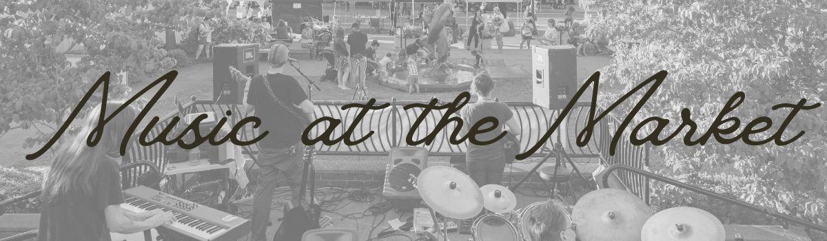 Black and white image of view from behind a band playing at Mayors Square
