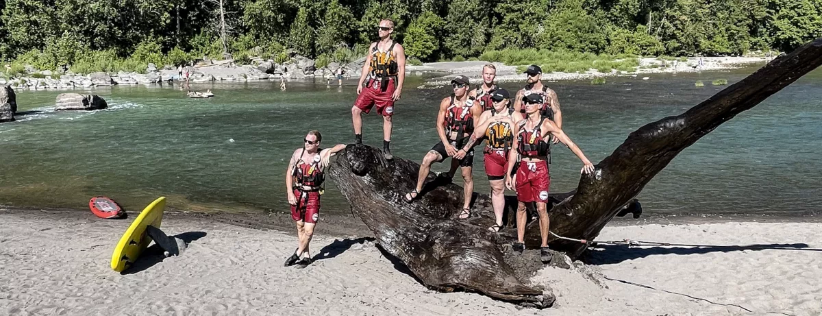 AMR lifeguards pose with the large snag that was removed from the Sandy River