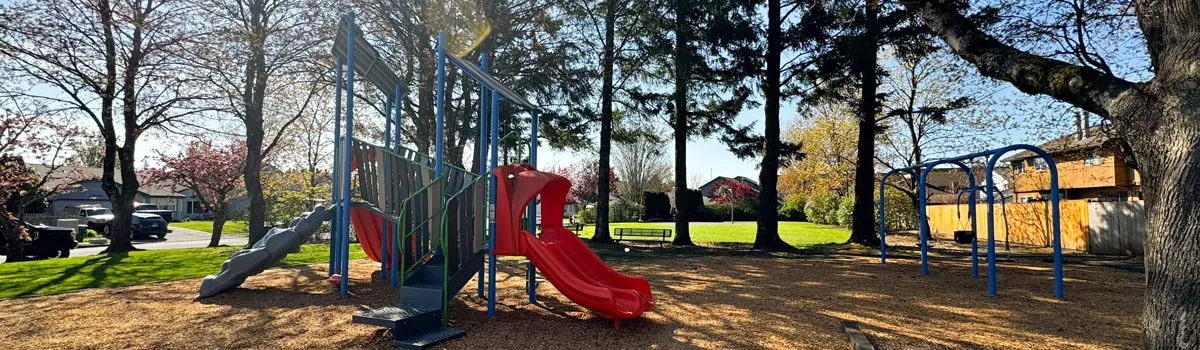 CP Park in Troutdale featuring playground equipment, swing set, and a basketball hoop in the background