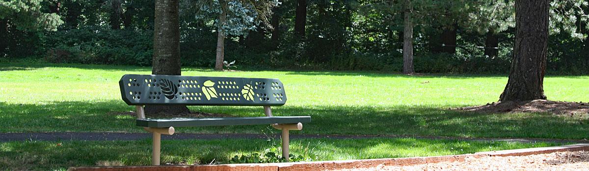 Park bench in the shade under a tree at Kiku Park in Troutdale