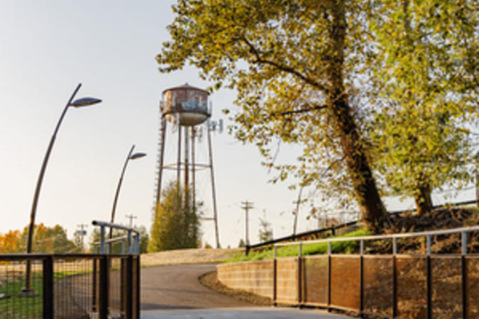 The historic water tower rises over Sharon Nesbit Heritage Park